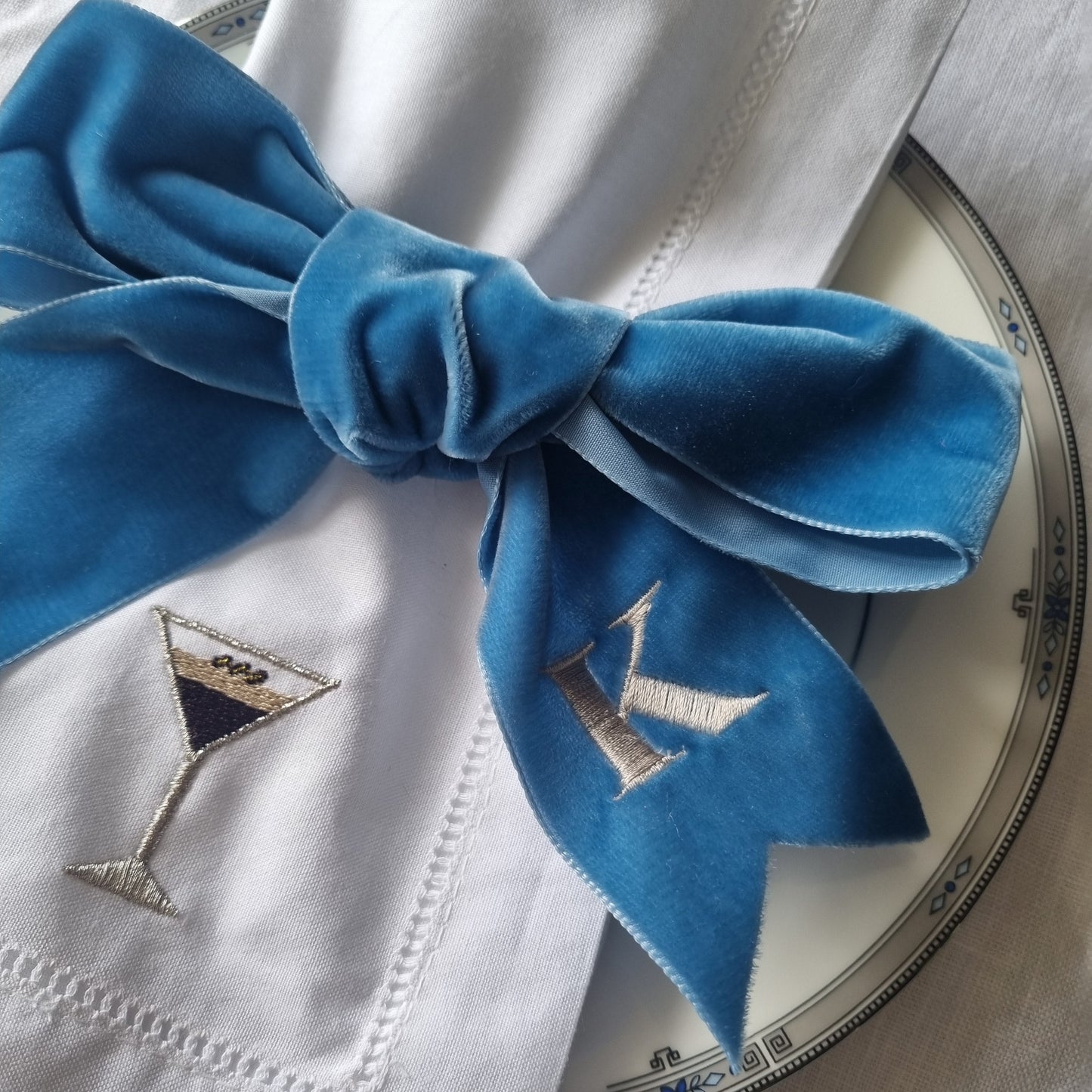 a blue velvet ribbon tied around a napkin