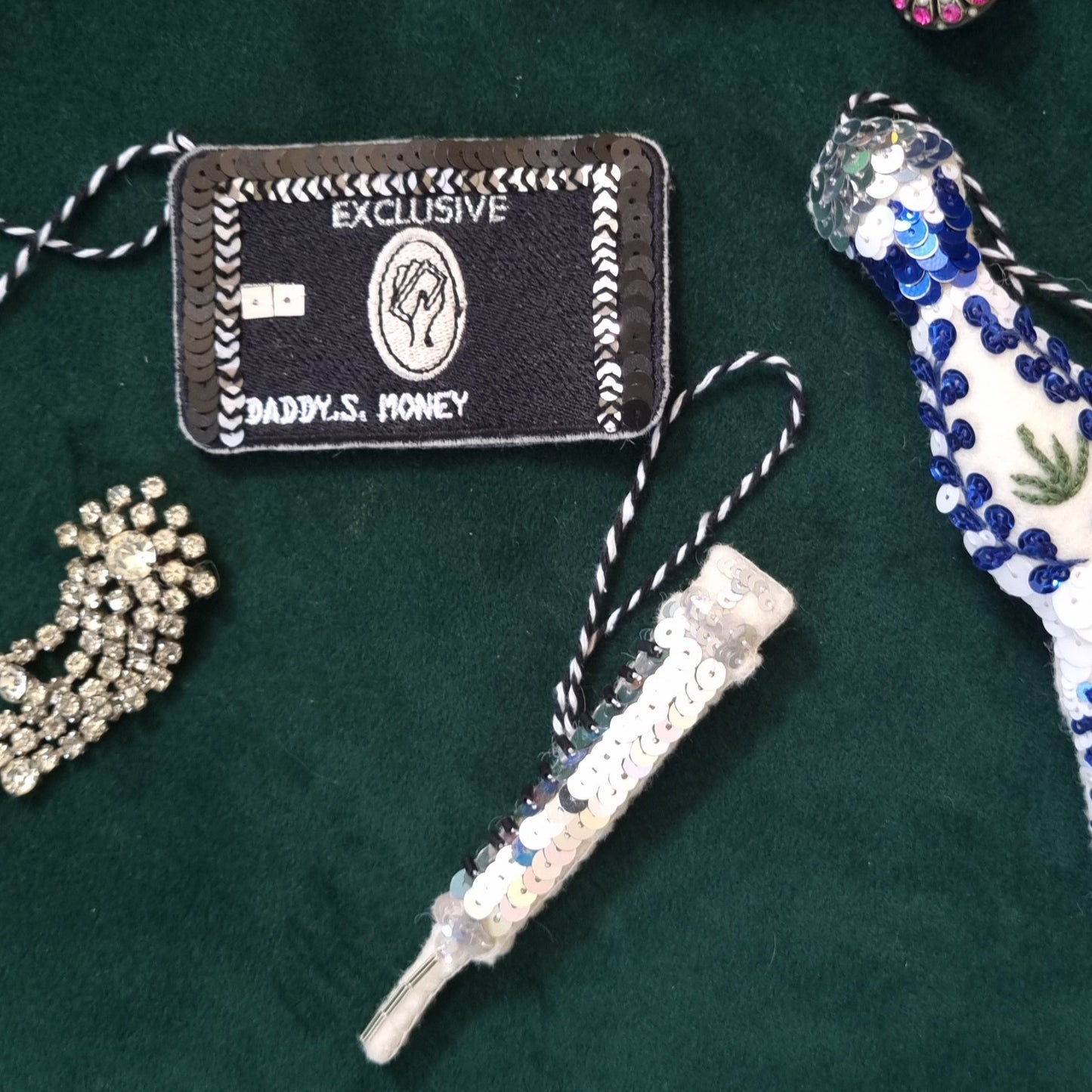 A credit card ornament, botox needle ornament on a green background