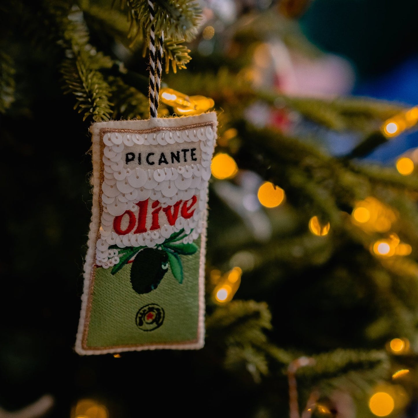 Sequinned and Embroidered Olive Tin Ornament on the tree