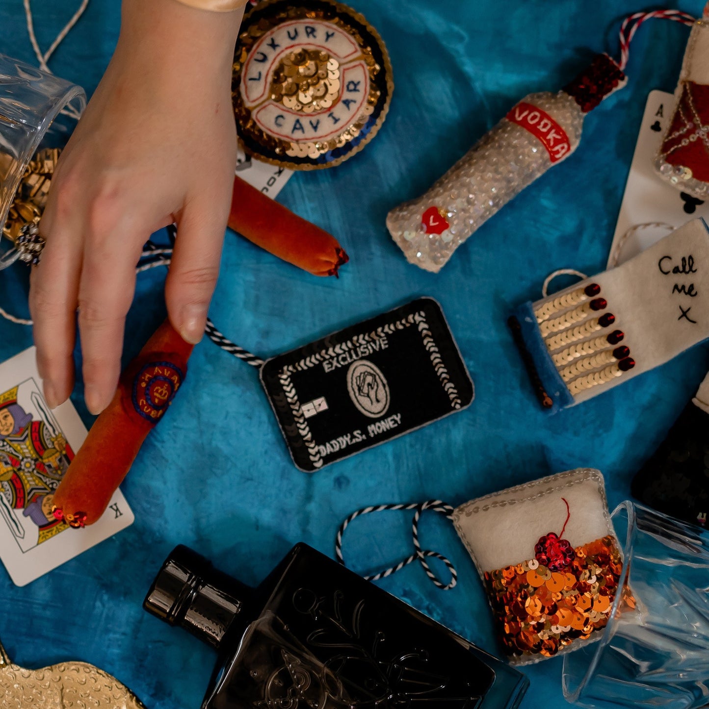 A collection of ornaments including a credit card embroidered sequin ornament