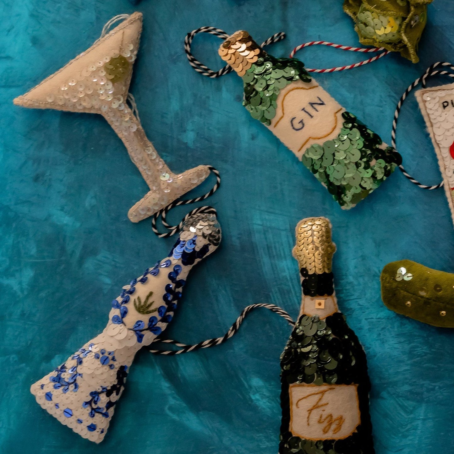 A collection of green and blue sequinned ornaments