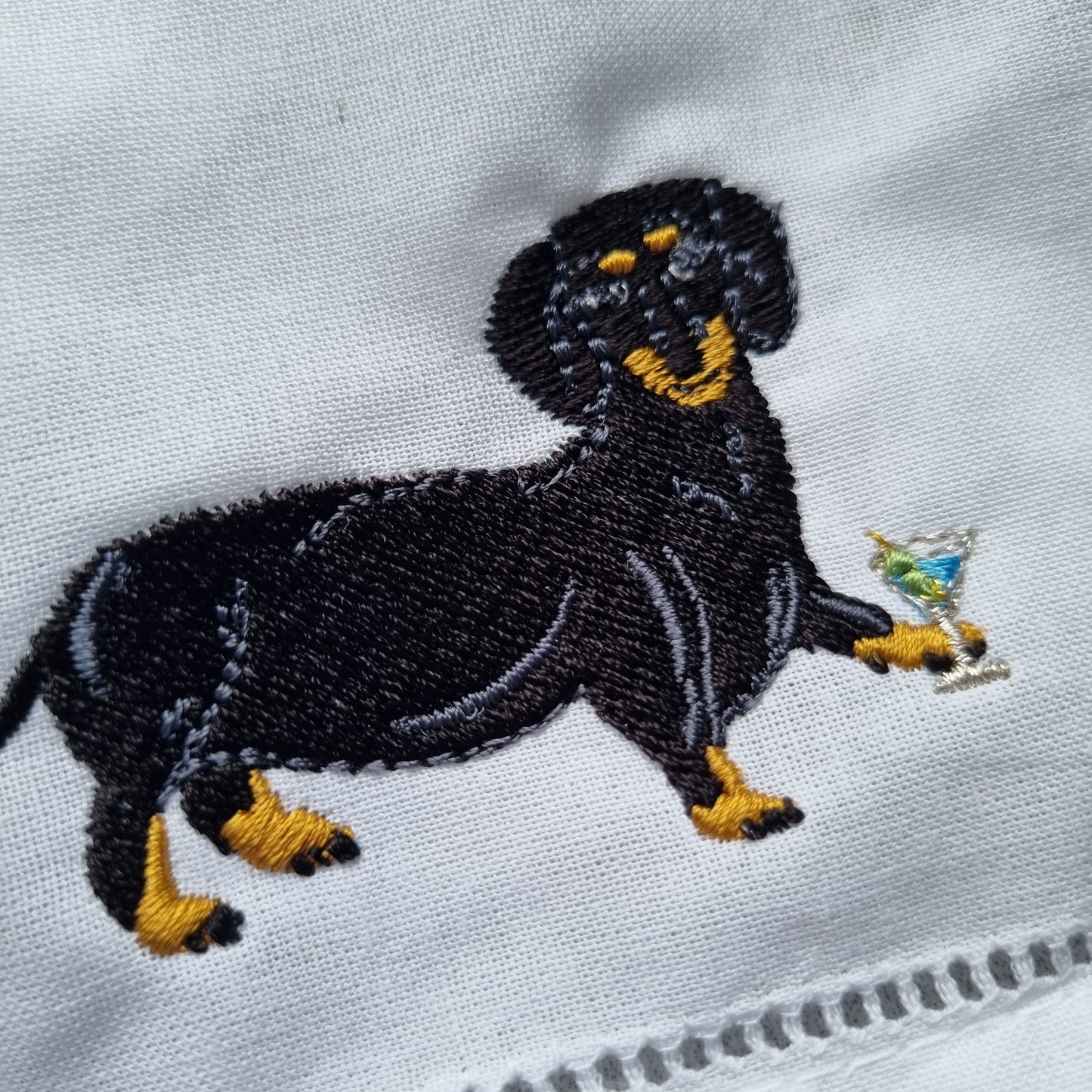Black and Tan Dachshund embroidered on a white napkin