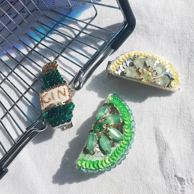 Sequin and Rhinestone Hair Clips, with a gin bottle one, a lemon slice one and a lime one