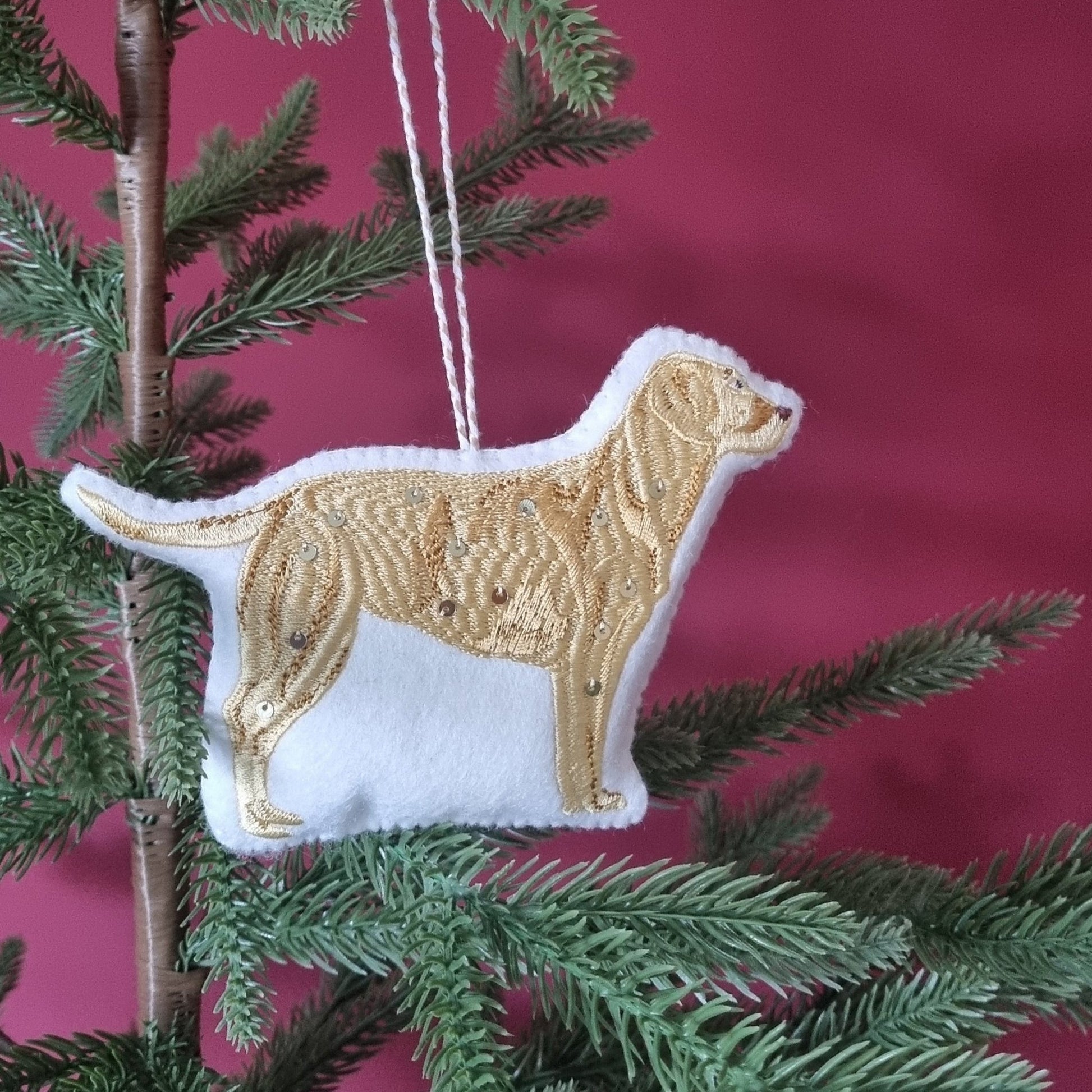 Golden Labrador ornament on a tree
