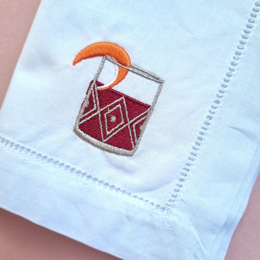 Embroidered Negroni Cocktail on a white cotton napkin