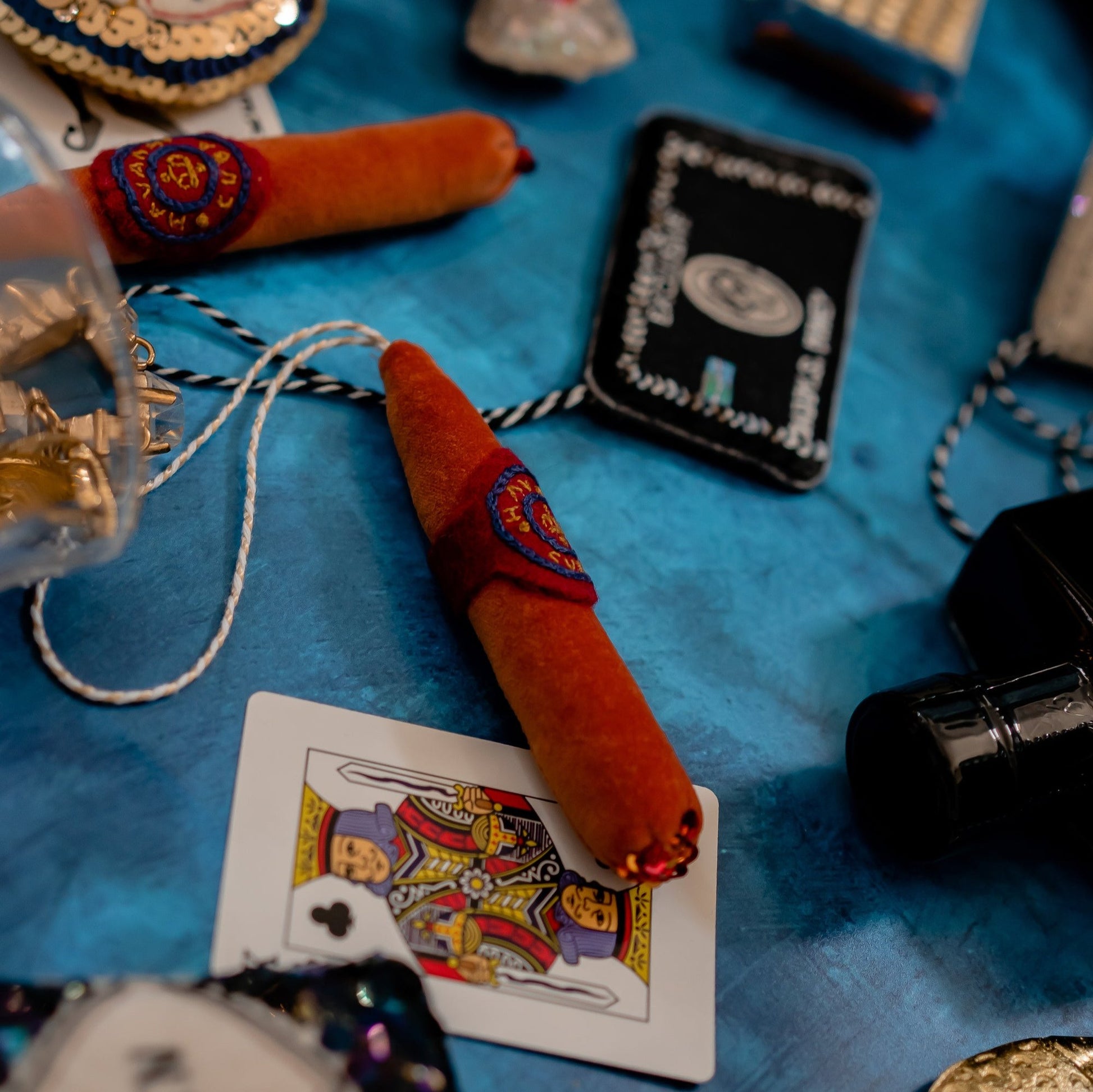 A close up of the Cigar Ornament on a blue background