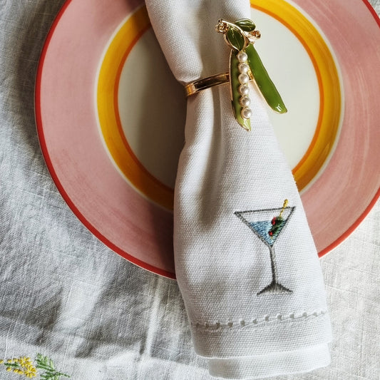 A white napkin with a classic martini embroidered on it