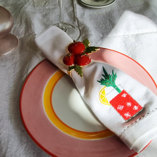 A white napkin embroidered with a bloody mary motif