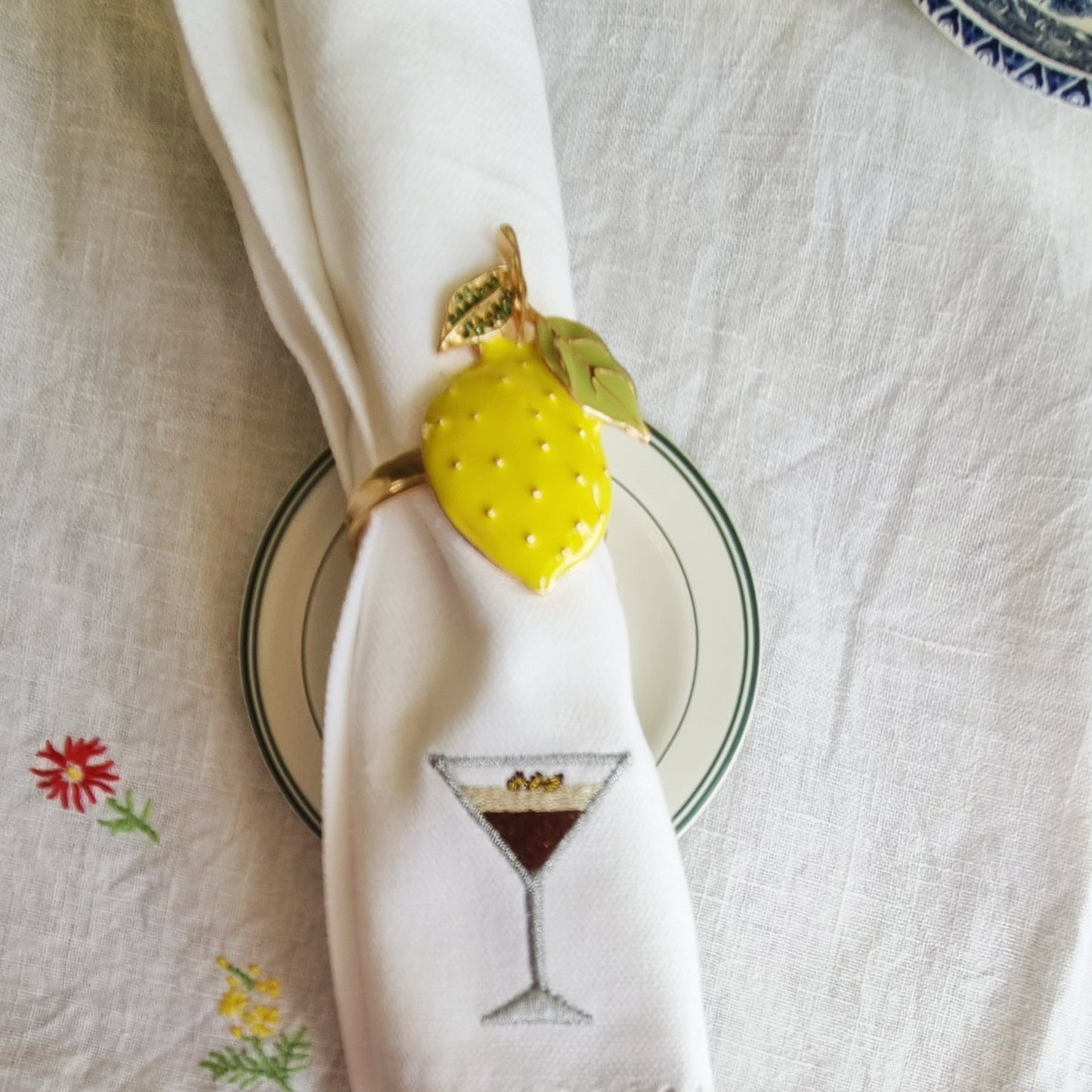 A white napkin with an espresso martini motif embroidered on it