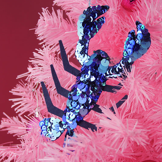 Lobster Sequin Hanging Ornament, a blue sequinned lobster ornament on a pink tree