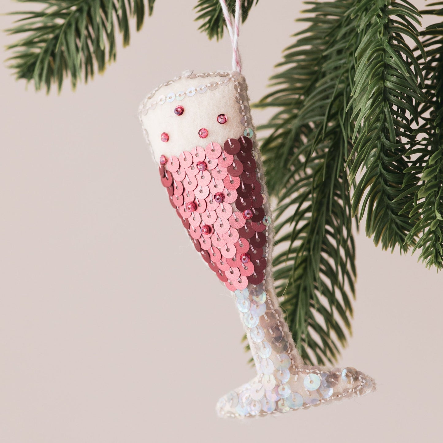 Pink champagne Flute Sequin Ornament, hanging on a tree
